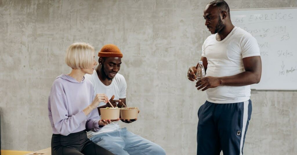 Three adults enjoy a nutritious meal together indoors, embracing a healthy lifestyle.